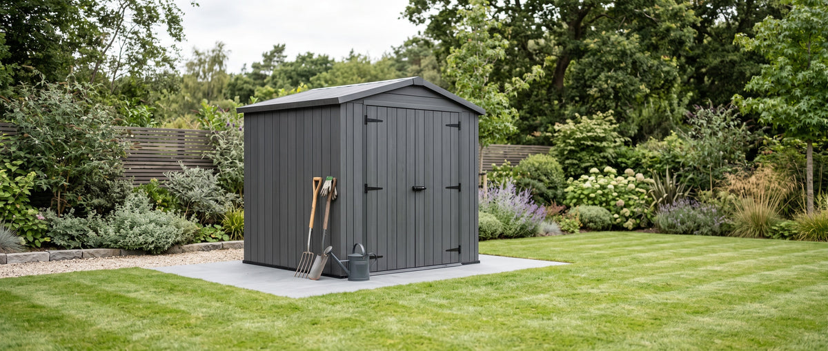 Dark grey garden storage shed on a lawn, part of Bambelou's Garden & Outdoor collection